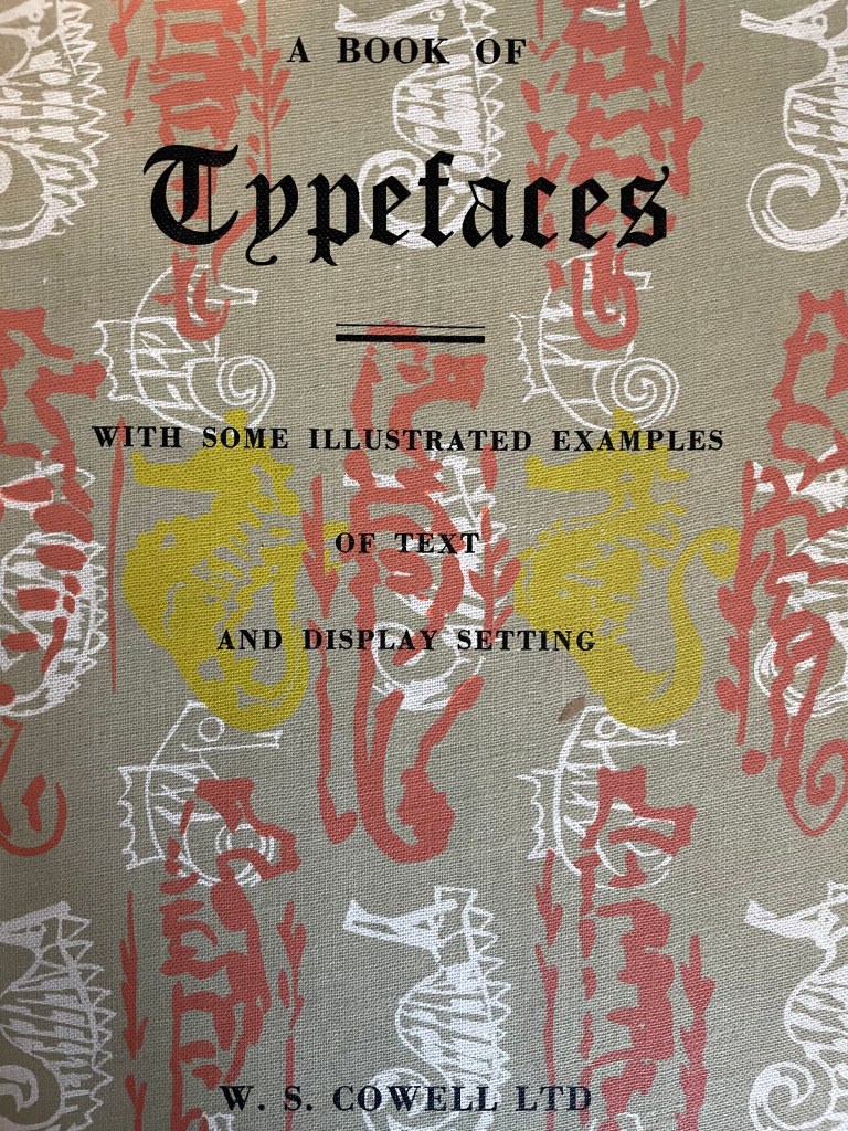 A photograph of a book cover featuring different illustrated seahorses in white, red and yellow, overlaid with the text: A Book of Typefaces, with some illustrated examples of text and display settings. W.S Cowell Ltd.