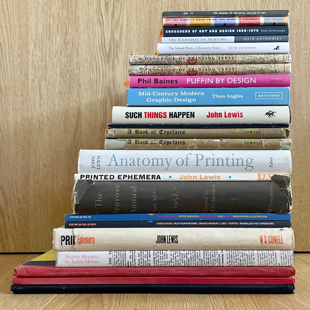 A photograph of a collection of books stacked one on top of the other, showing their spines.