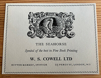 A photograph of a printed book plate—a rectangle of paper with an illustrated W.S. Cowell emblem of a seahorse, and the text: The Seahorse, symbol of the best in Fine Book Printing, W.S.Cowell Ltd, Butter Market, Ipswich, 23 Percy Street, London, W1.