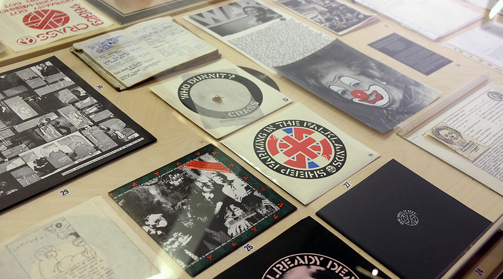 A display cabinet featuring seven inch single sleeves for the band Crass