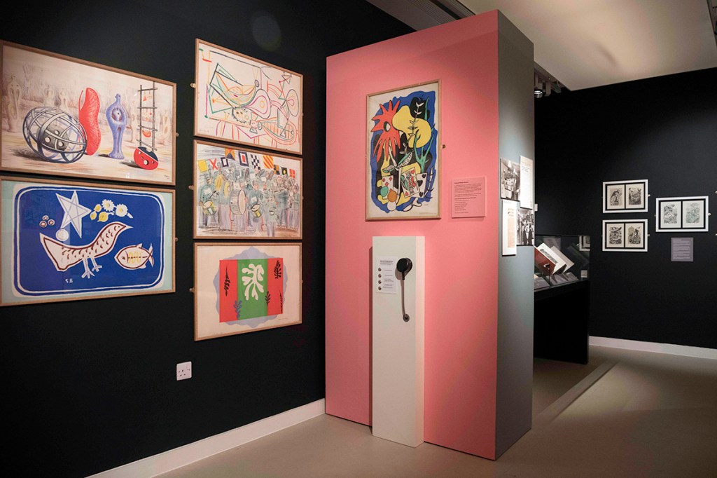 A photograph of an exhibition space. There is framed artwork on the walls.