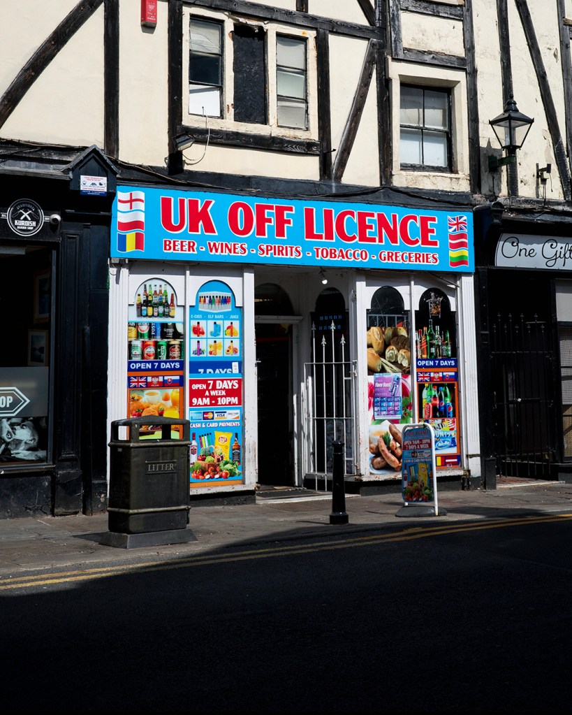 A convenience store with a sign reading: UK Off Licence.