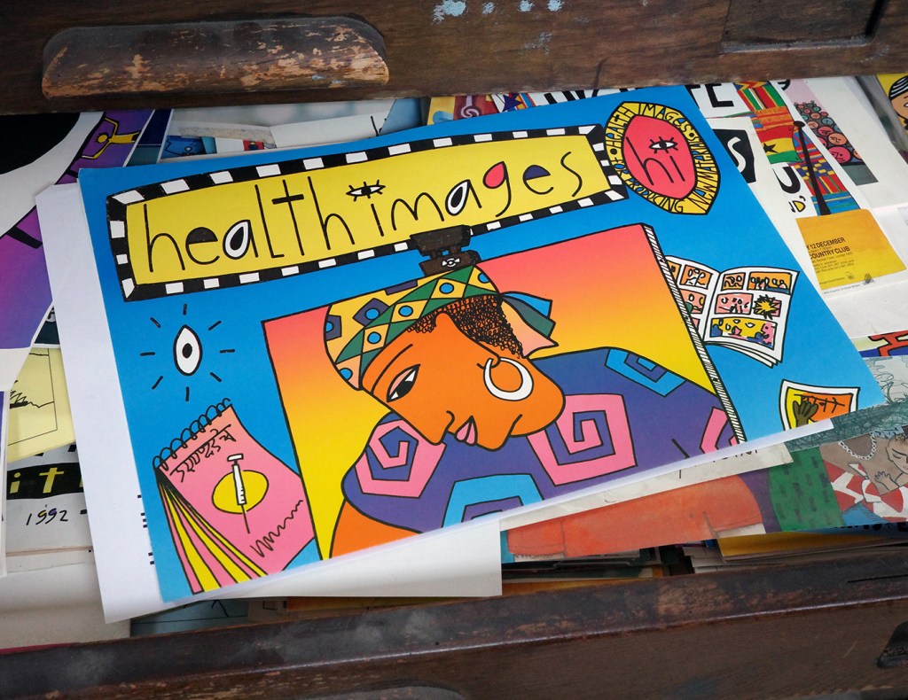An open draw with a colourful poster of a woman and the words: Health Images.