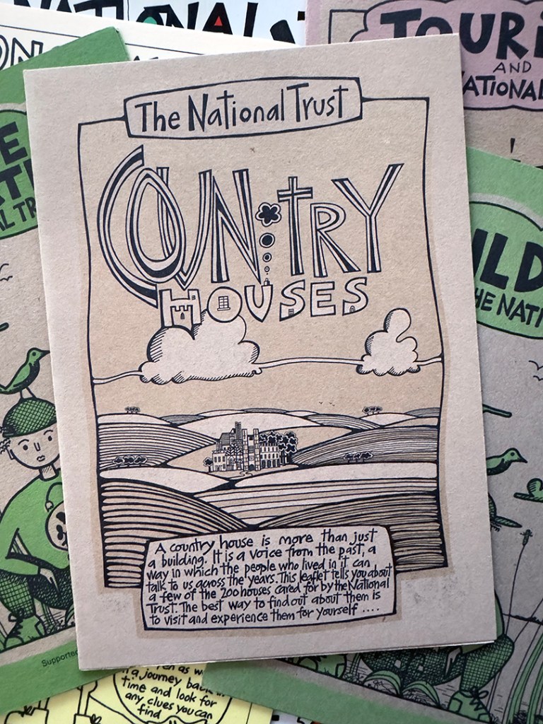 Leaflets, with the top one reading: The national Trust Country Houses, and an illustration of a grand building set bin rolling hills.